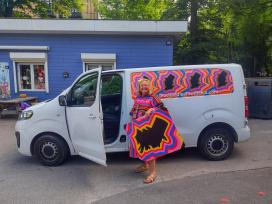 Benedicte Riis alias Tante Andante foran sin H.C. Andersen Bus